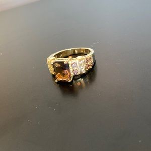 Ring with amber coloured stone and side stones